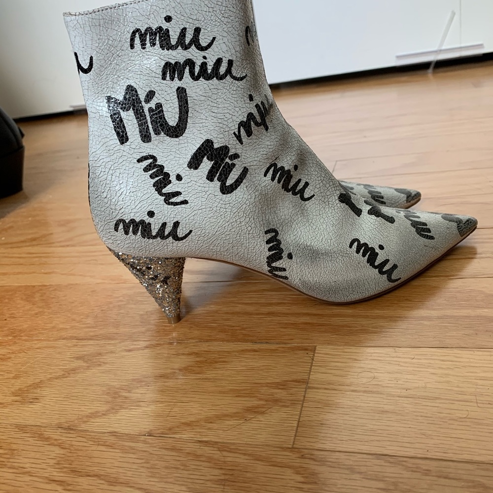 Graffiti covered pair ankle boots